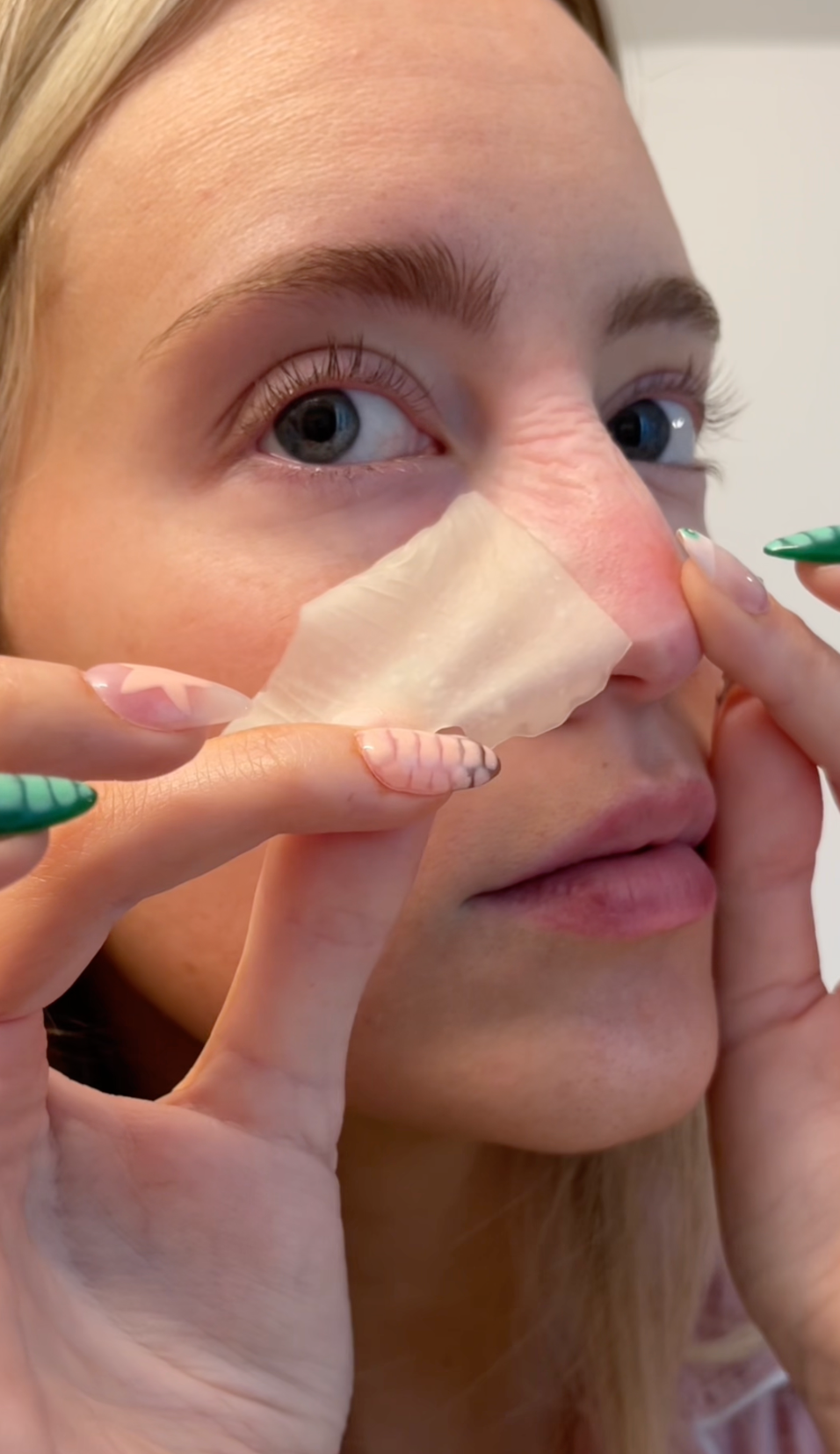 A girl removing vue nose patch 